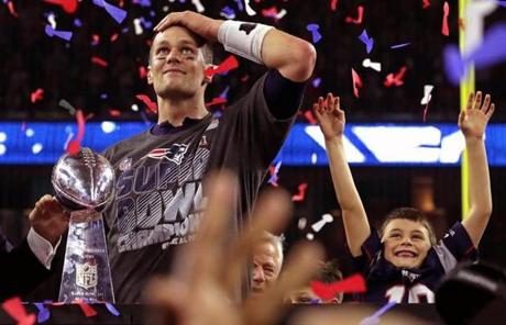 Tom Brady and his son celebrated with the Lombardi trophy. 
